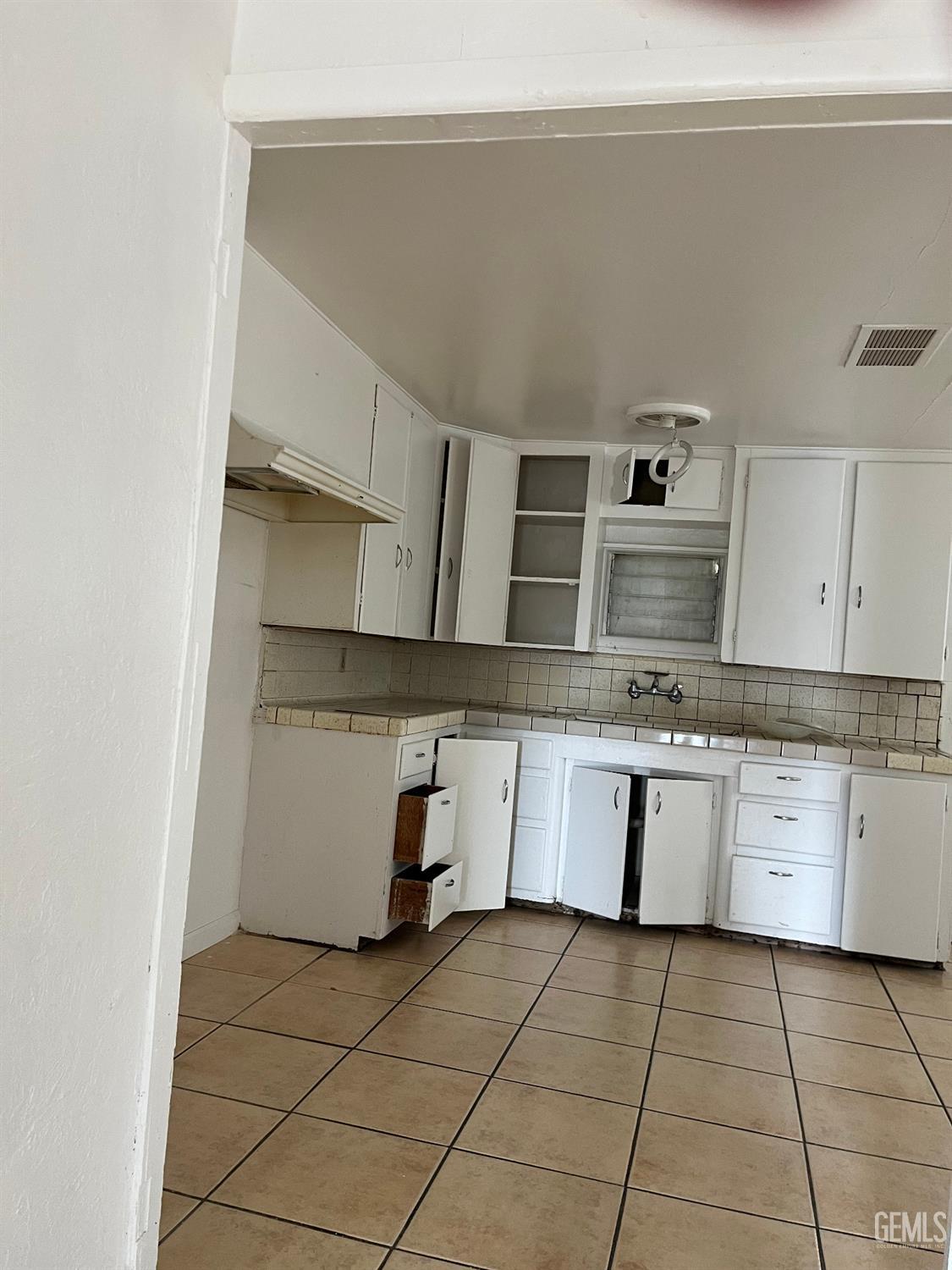 Undisclosed Address Wasco, CA 93280 - Photo 3 of 17 a kitchen with stainless steel appliances granite countertop a sink and white cabinets