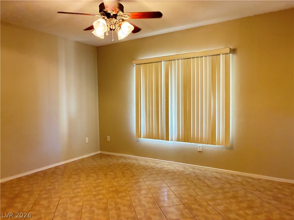 A well-proportioned bedroom with ample natural light and a comforting ceiling fan.