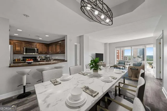 an empty room with wooden floor and a rug