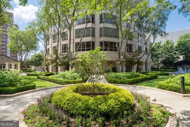 a view of a balcony with chairs and potted plants
