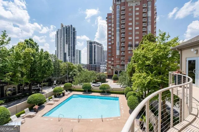 a view of a dining room with furniture a kitchen and chandelier
