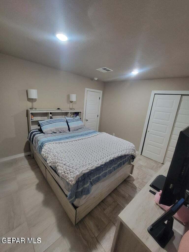 11531 Ernest Road Socorro, TX 79927 - Photo 20 of 36 a bedroom with a bed and a flat screen tv
