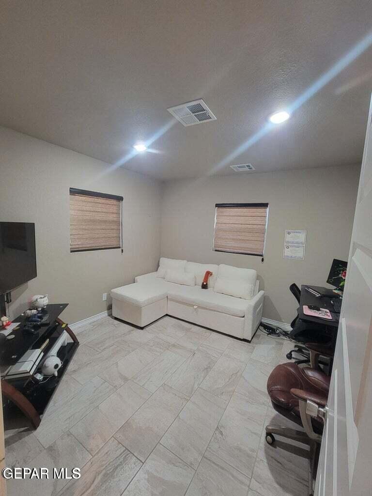 11531 Ernest Road Socorro, TX 79927 - Photo 21 of 36 a bedroom with furniture and a window