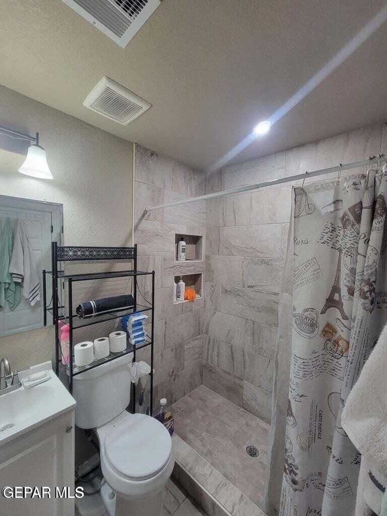 11531 Ernest Road Socorro, TX 79927 - Photo 22 of 36 a bathroom with a toilet and a shower