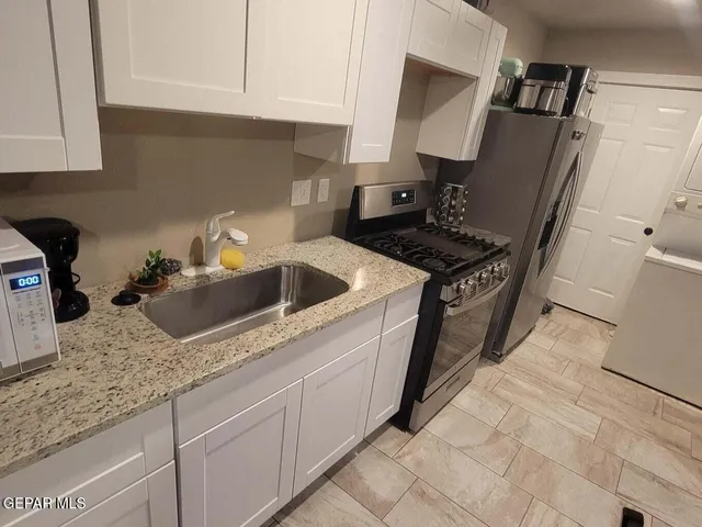 a kitchen with a stove and a refrigerator