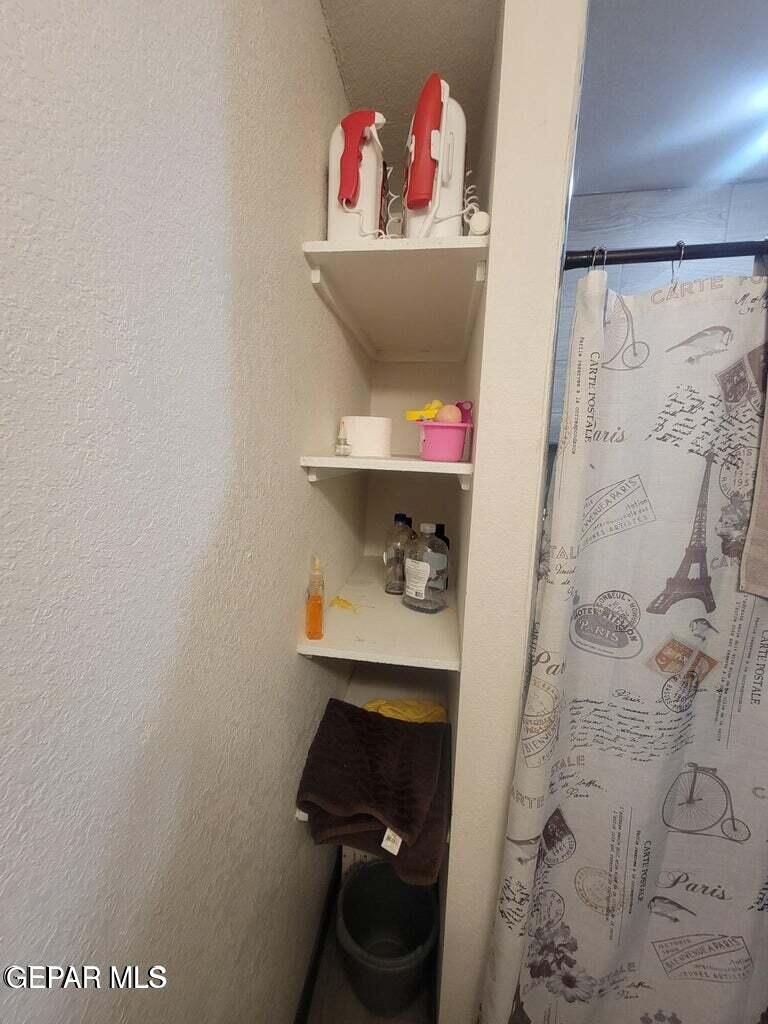 11531 Ernest Road Socorro, TX 79927 - Photo 30 of 36 a room with a wooden floor and a stool