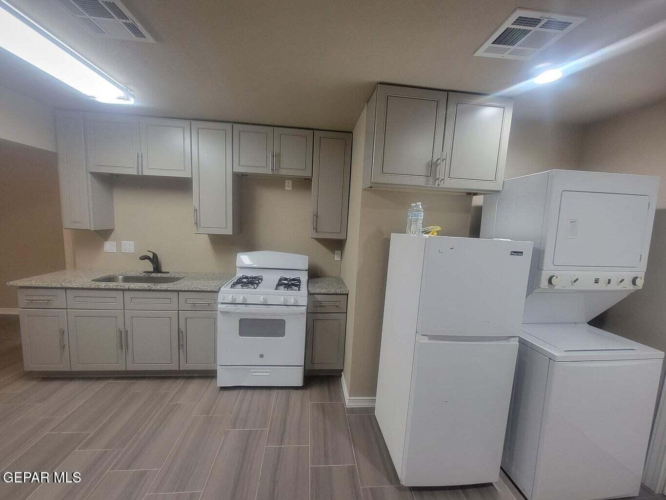11531 Ernest Road Socorro, TX 79927 - Photo 3 of 36 a kitchen with a stove a sink and a refrigerator