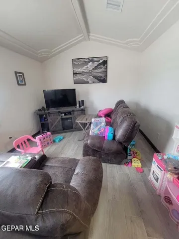 a room with a bed mirror and a bathroom