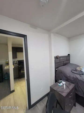 a view of a hallway with wooden floor and closet