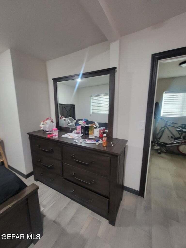 11531 Ernest Road Socorro, TX 79927 - Photo 33 of 36 a room with a bed mirror and a bathroom