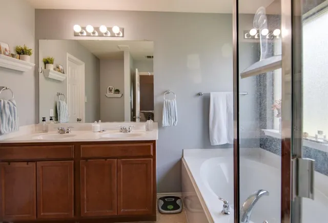 a bathroom with a double vanity sink and a mirror