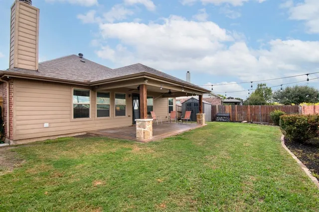 a view of a house with a yard and sitting area