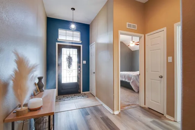a very nice looking room with wooden floor and a bathroom