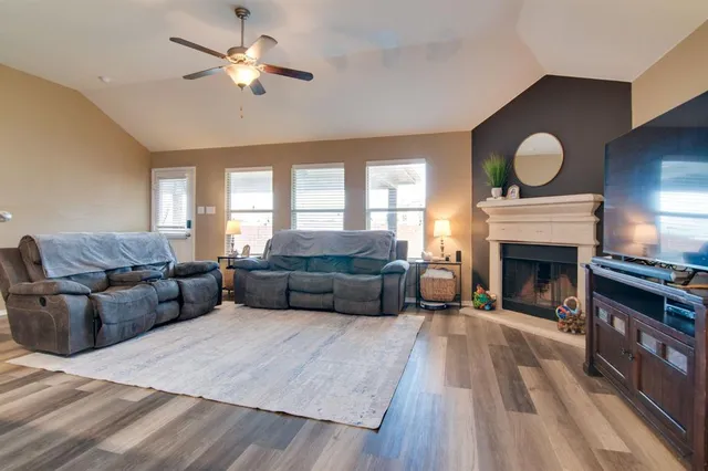 a living room with furniture and a fireplace