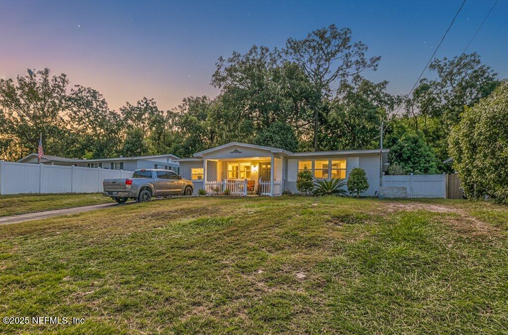 1860 Embassy Drive Jacksonville, FL 32207 - Photo 1 of 53 a front view of a house with a yard and trees
