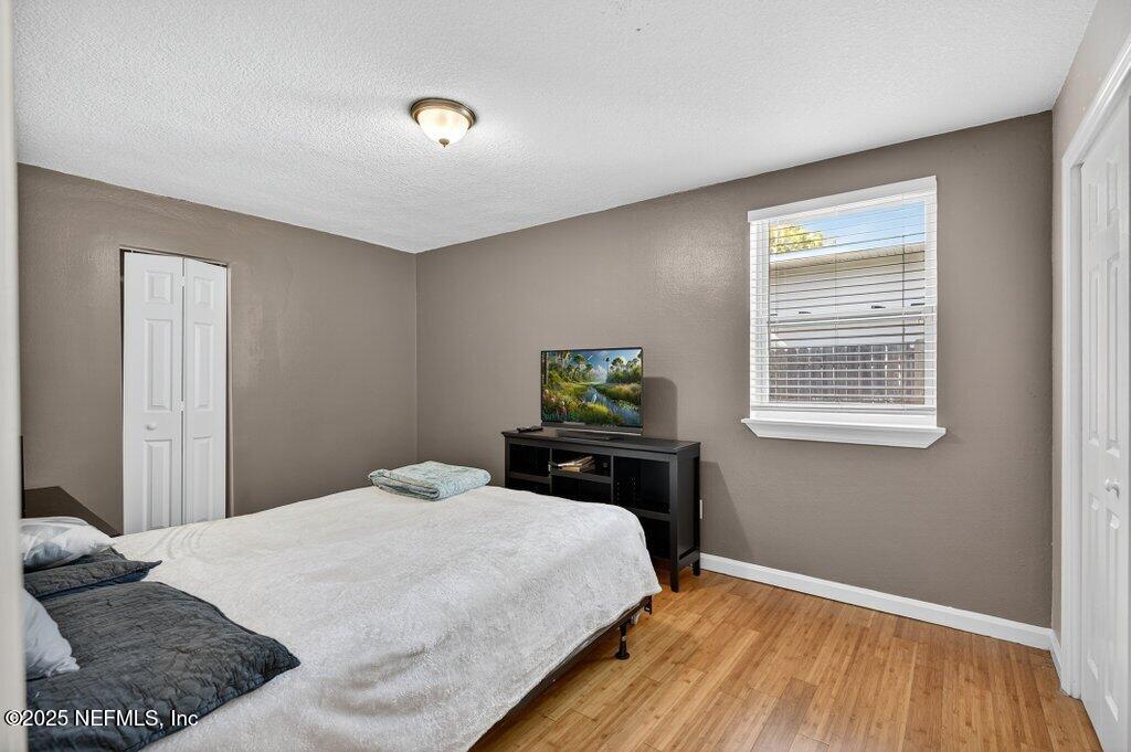 1860 Embassy Drive Jacksonville, FL 32207 - Photo 20 of 53 a bedroom with a bed and wooden floor