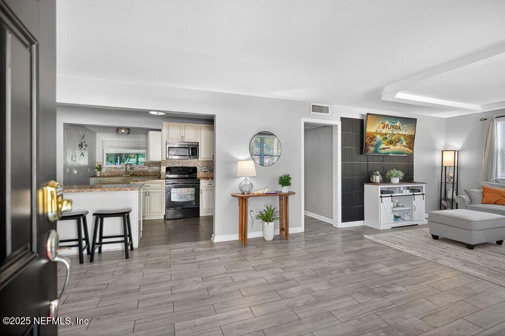 1860 Embassy Drive Jacksonville, FL 32207 - Photo 2 of 53 a kitchen with stainless steel appliances kitchen island granite countertop a refrigerator and cabinets