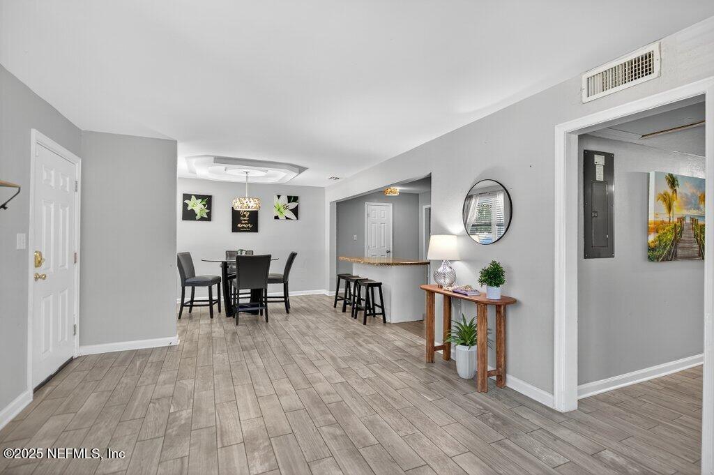 1860 Embassy Drive Jacksonville, FL 32207 - Photo 27 of 53 a view of dining room and livingroom with furniture wooden floor mirror and window