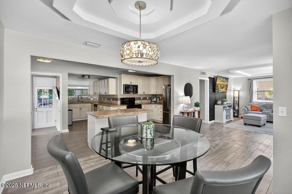 1860 Embassy Drive Jacksonville, FL 32207 - Photo 31 of 53 a view of a dining room with furniture and a chandelier