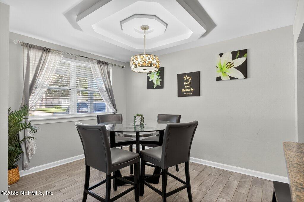 1860 Embassy Drive Jacksonville, FL 32207 - Photo 32 of 53 a view of a dining room with furniture a chandelier and wooden floor