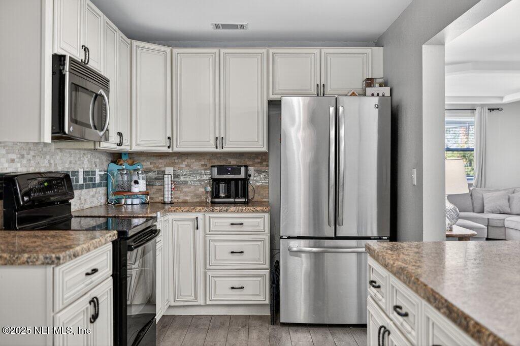 1860 Embassy Drive Jacksonville, FL 32207 - Photo 36 of 53 a kitchen with stainless steel appliances granite countertop a refrigerator sink and stove