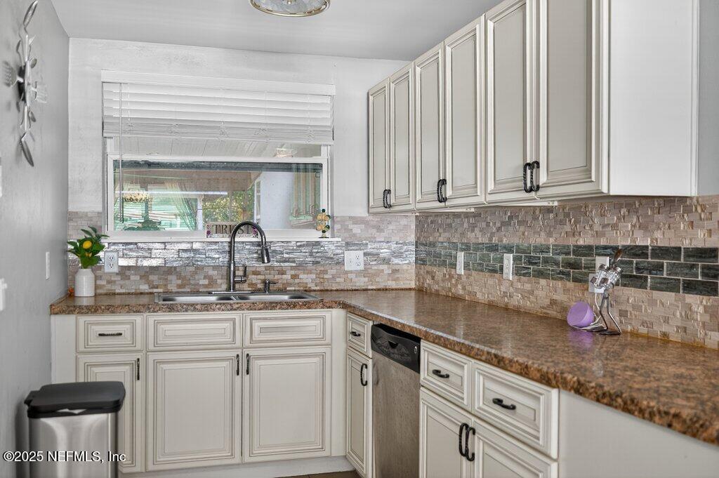 1860 Embassy Drive Jacksonville, FL 32207 - Photo 37 of 53 a kitchen with granite countertop white cabinets and white appliances