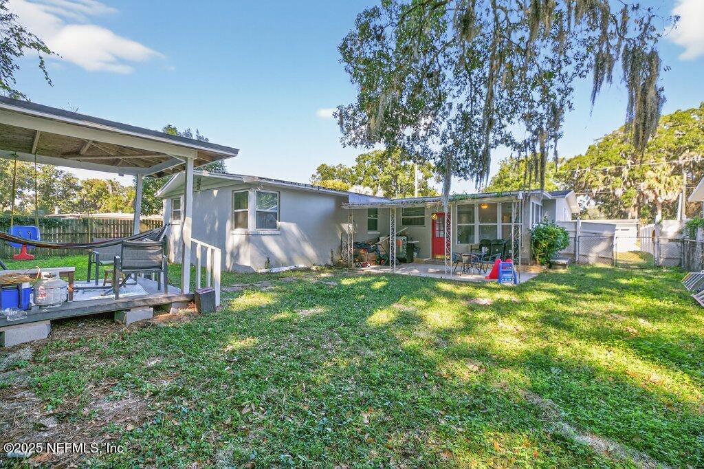 1860 Embassy Drive Jacksonville, FL 32207 - Photo 49 of 53 a view of a house with a backyard and a patio