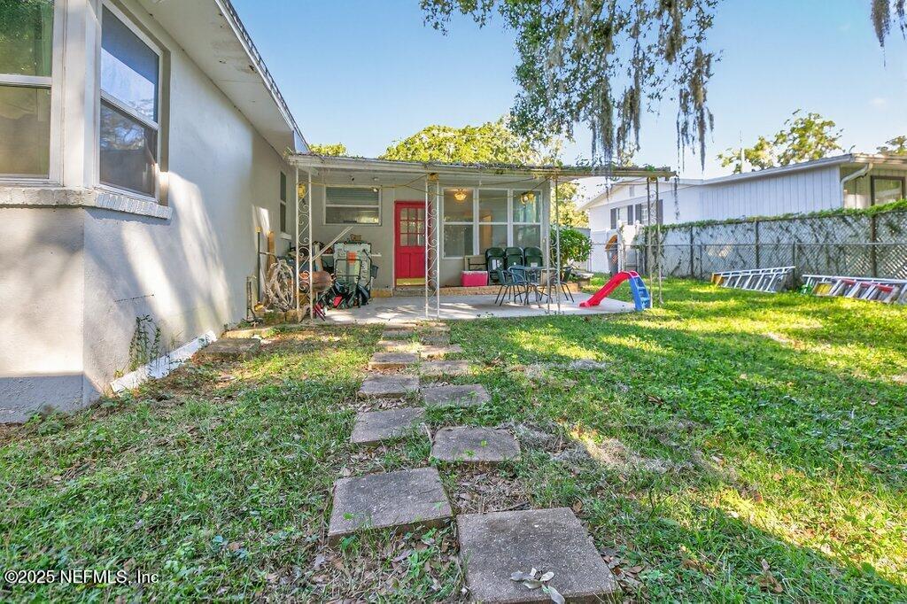 1860 Embassy Drive Jacksonville, FL 32207 - Photo 5 of 53 a view of a house with a yard and sitting area