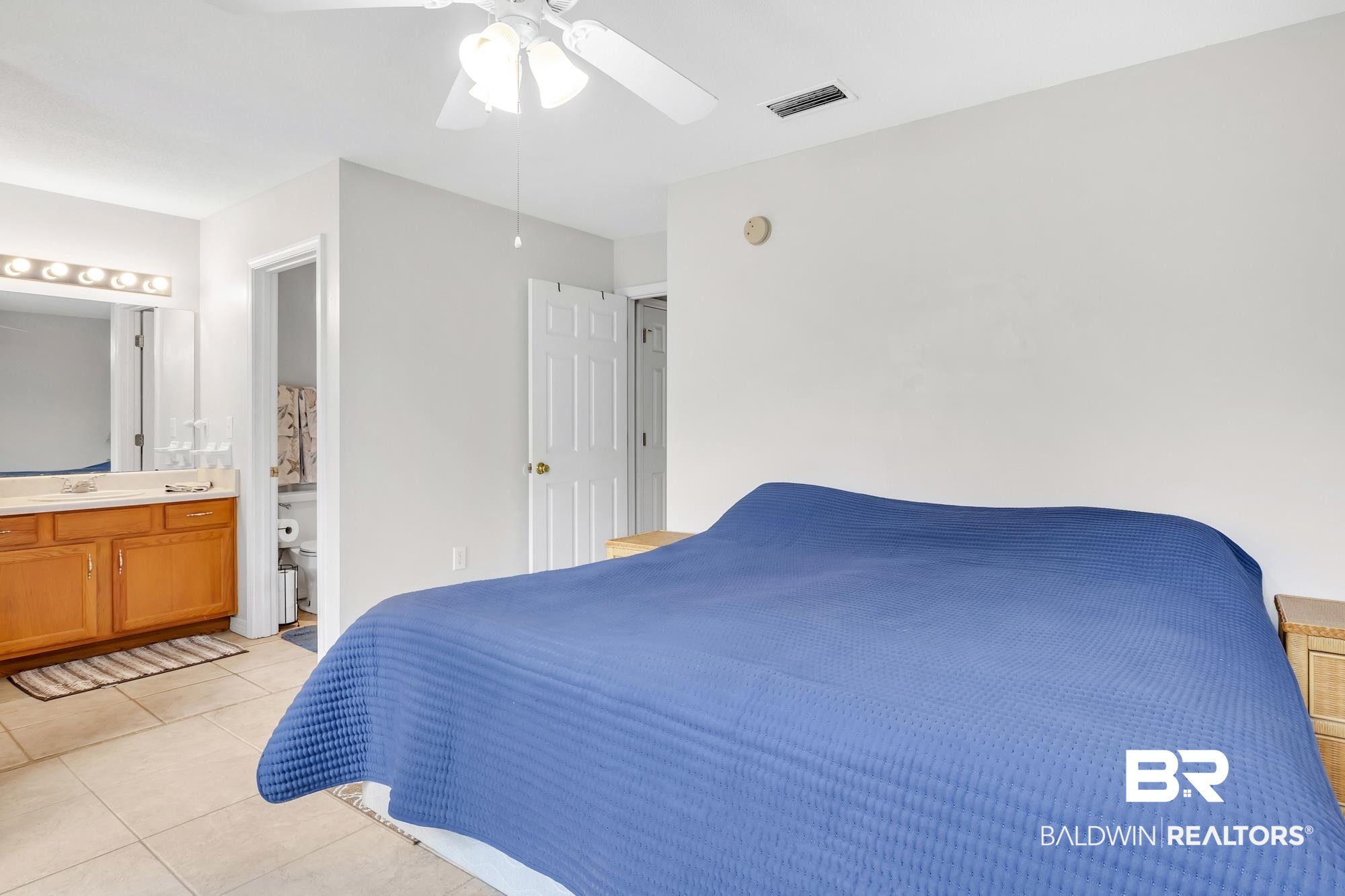 105 Cluster Oaks Court Foley, AL 36535 - Photo 26 of 26 Bedroom with light tile patterned floors, ensuite bathroom, and ceiling fan