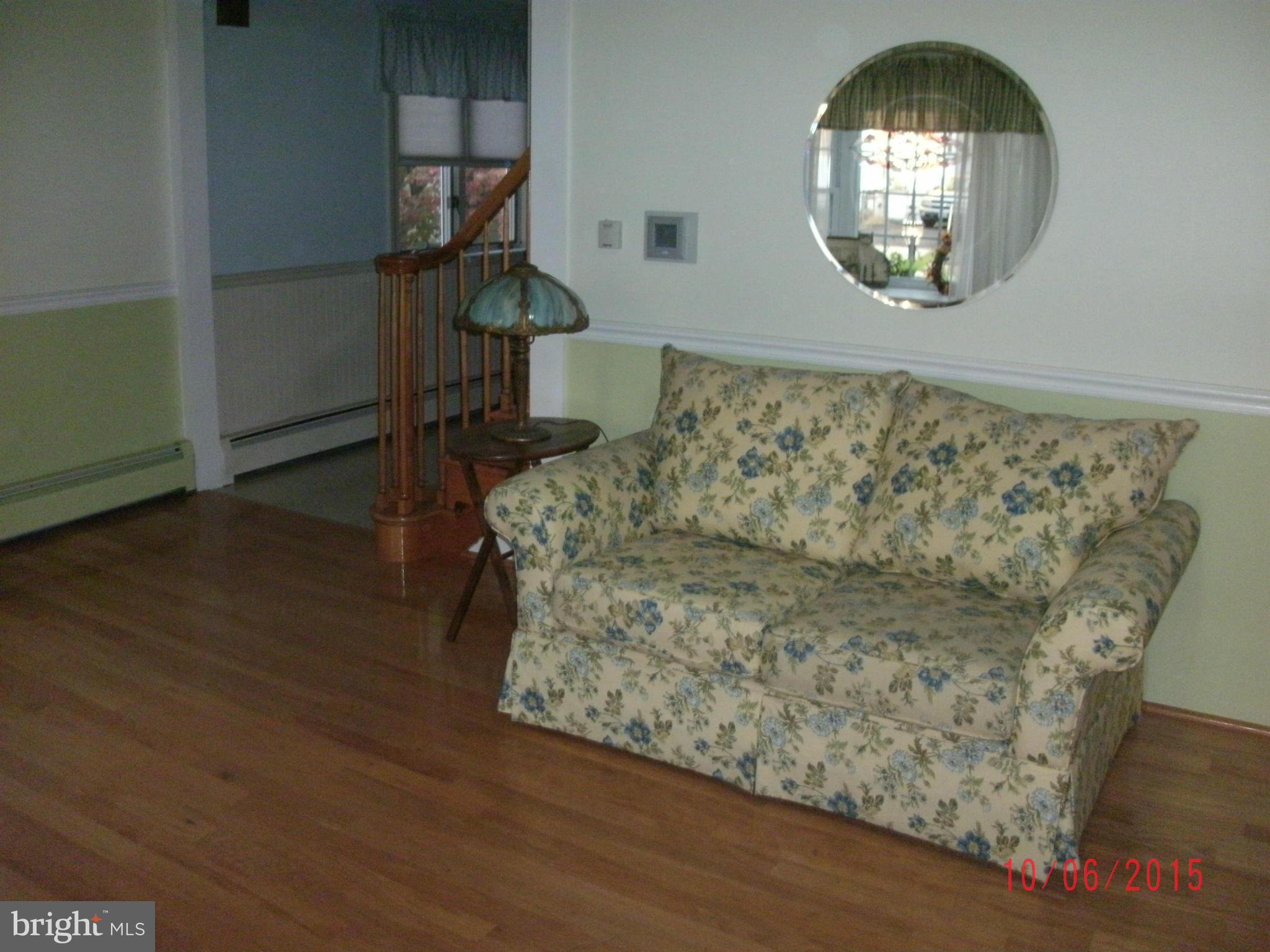 323 Nicholson Road Baltimore, MD 21221 - Photo 11 of 30 a living room with couch and a mirror