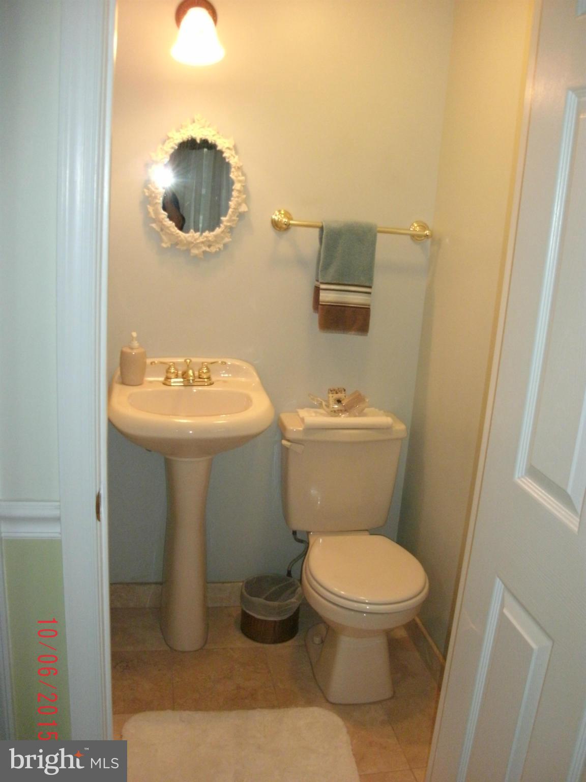 323 Nicholson Road Baltimore, MD 21221 - Photo 17 of 30 a bathroom with a toilet sink and mirror