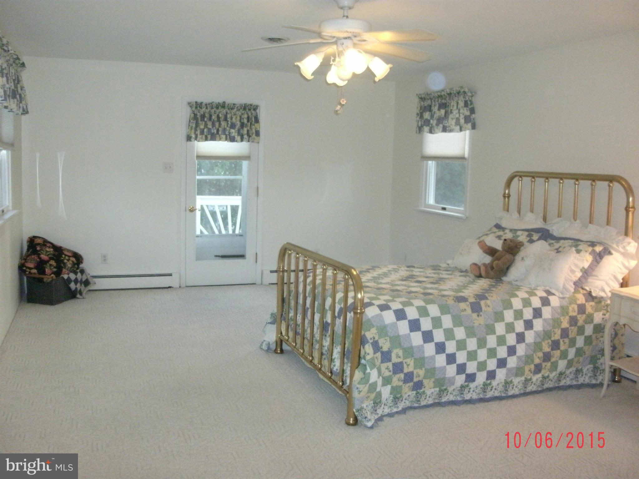 323 Nicholson Road Baltimore, MD 21221 - Photo 19 of 30 a bedroom with a bed and a chandelier