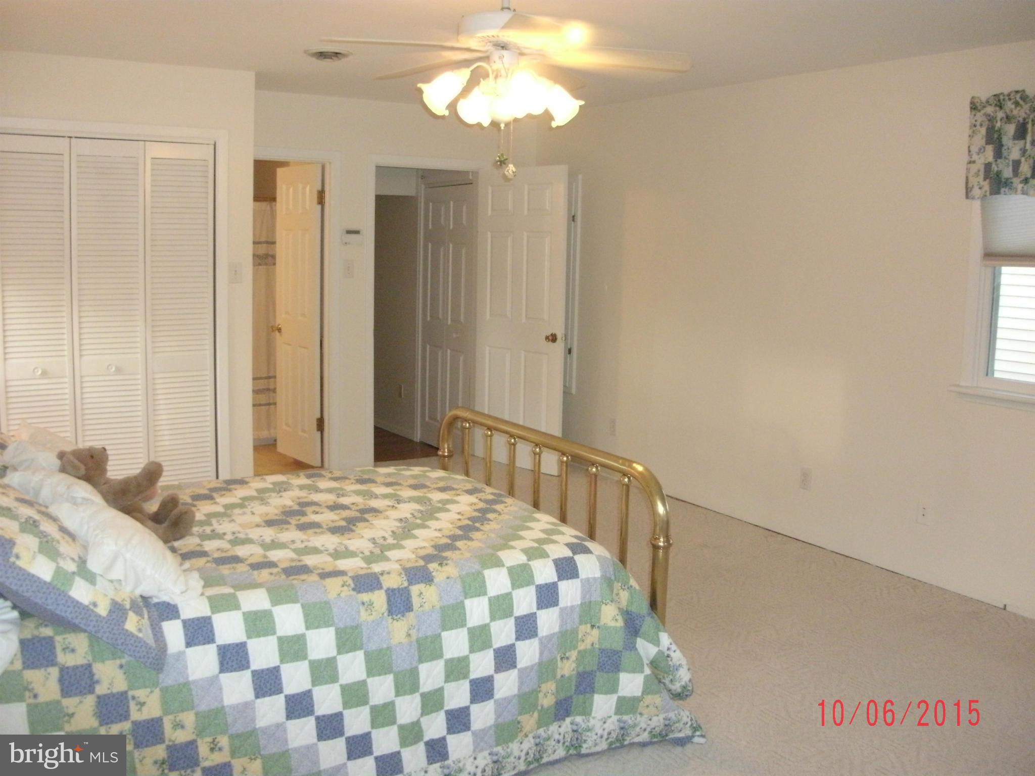 323 Nicholson Road Baltimore, MD 21221 - Photo 20 of 30 a bedroom with a bed and a chandelier