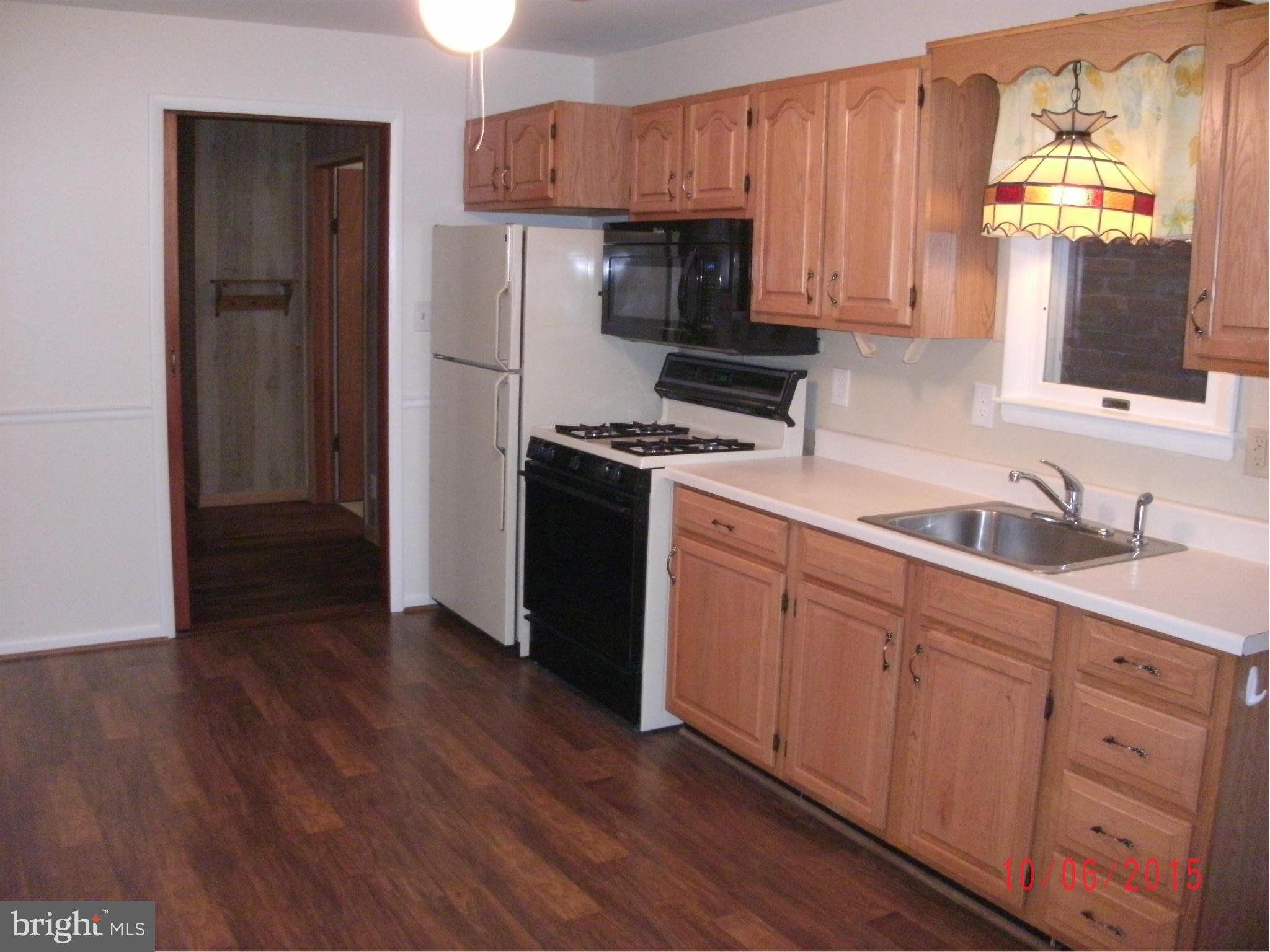 323 Nicholson Road Baltimore, MD 21221 - Photo 26 of 30 a kitchen with stainless steel appliances granite countertop a refrigerator stove and sink