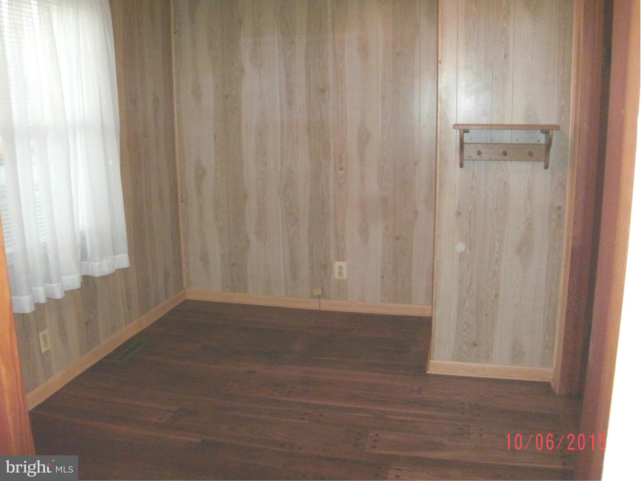 323 Nicholson Road Baltimore, MD 21221 - Photo 27 of 30 a view of a small space with wooden floor and a window