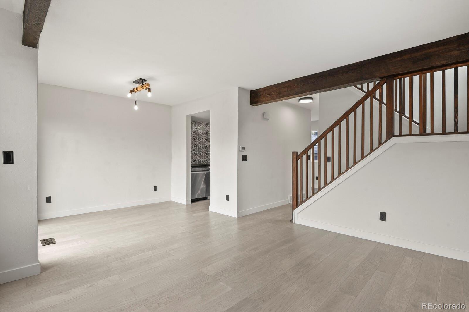 8771 Carr Loop Arvada, CO 80005 - Photo 2 of 16 a view of a hallway with staircase