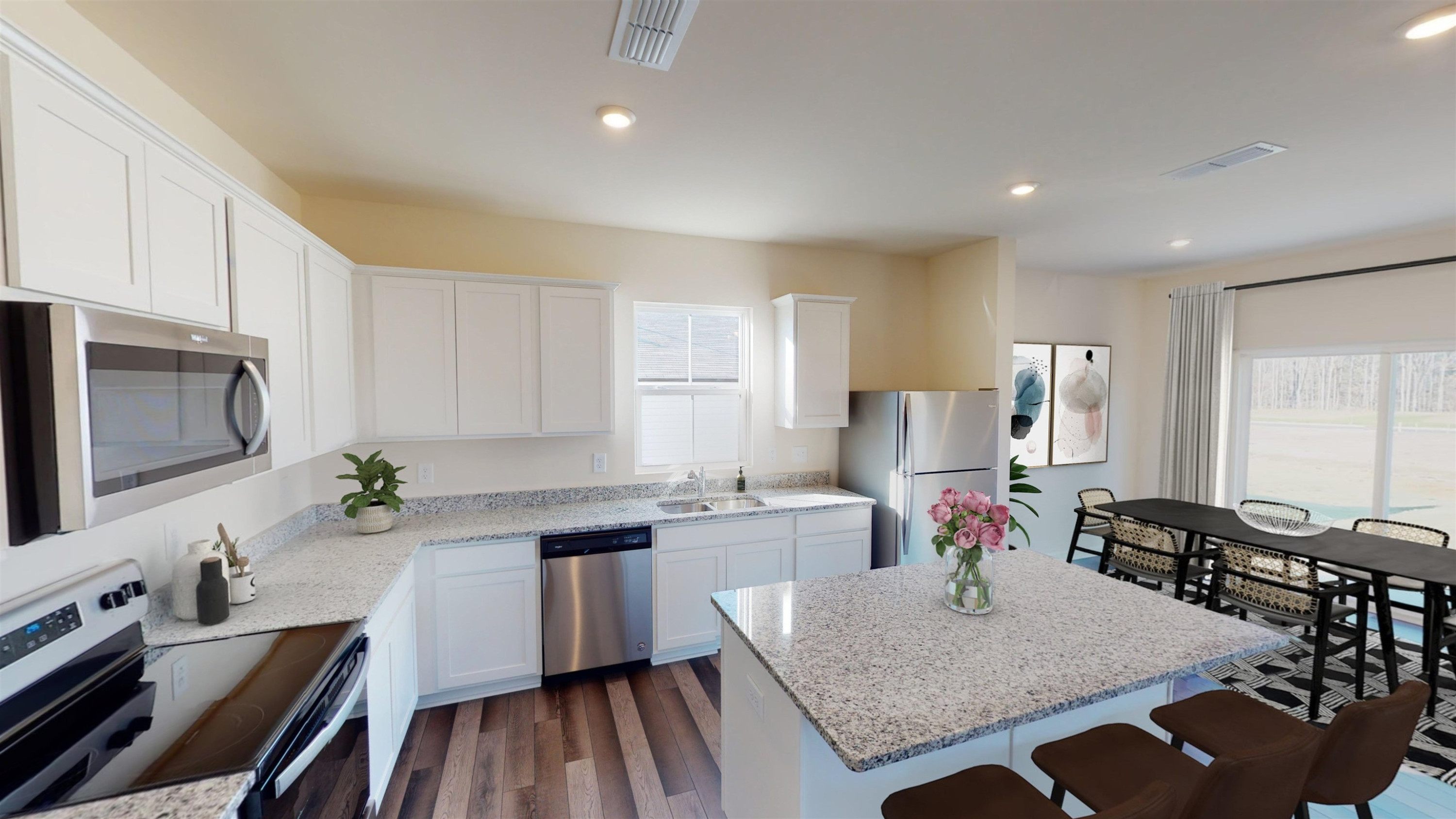 3504 Dragonfly River Raleigh, NC 27604 - Photo 5 of 27 a kitchen with stainless steel appliances granite countertop a stove top oven a sink dishwasher and cabinets with wooden floor