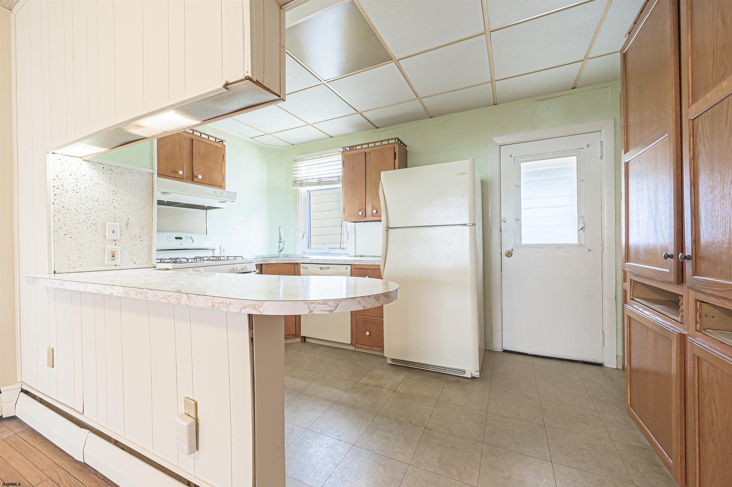 116 North Cornwall Avenue Ventnor City, NJ 08406 - Photo 13 of 28 a kitchen with stainless steel appliances a refrigerator and a sink