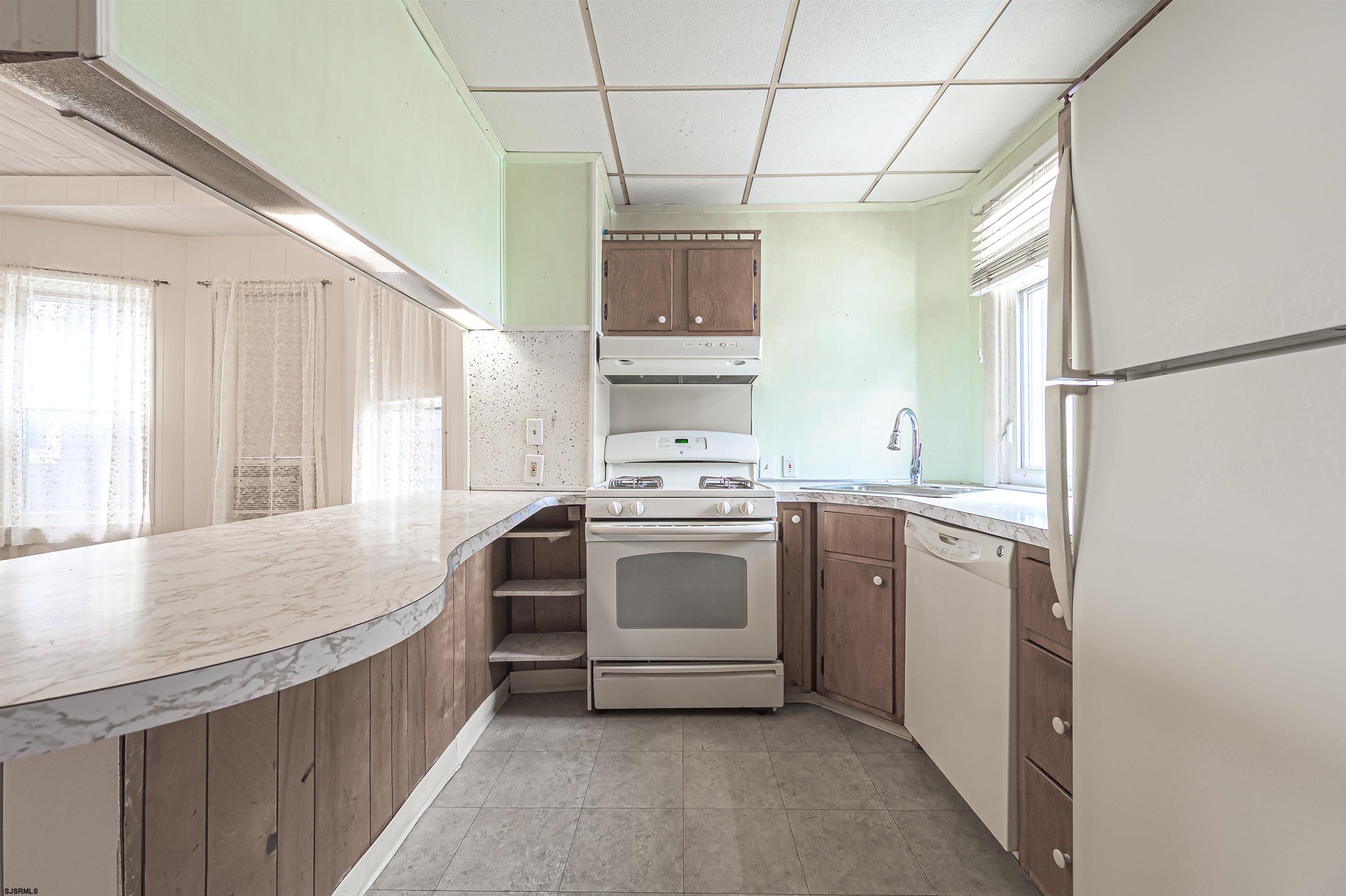 116 North Cornwall Avenue Ventnor City, NJ 08406 - Photo 14 of 28 a kitchen with a stove cabinets and a refrigerator