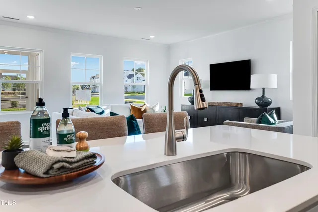 a kitchen with a sink and living room