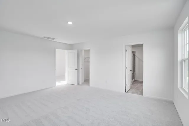 a view of an empty room and a window