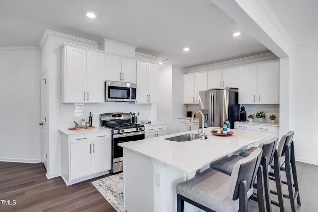 a kitchen with a white cabinets and stainless steel appliances