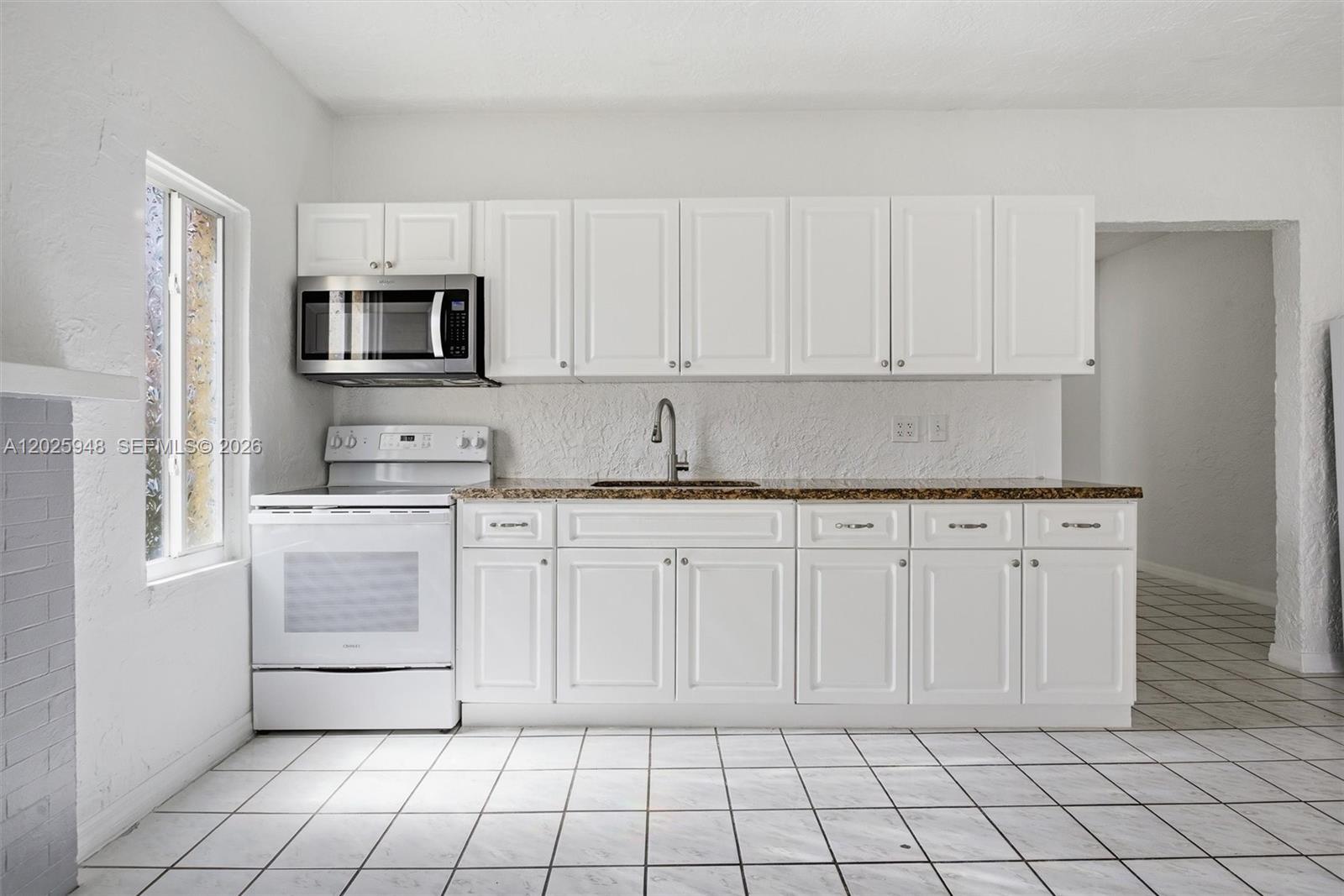 1745 Southwest 17th Street, Unit 2 Miami, FL 33145 - Photo 10 of 32 a kitchen with white cabinets