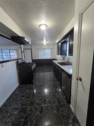a kitchen with stainless steel appliances a refrigerator and a stove top oven