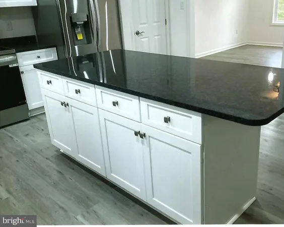 a kitchen with white cabinets