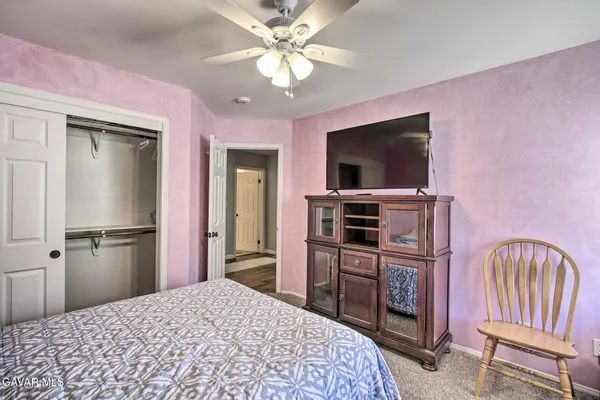 a bedroom with a bed and a television