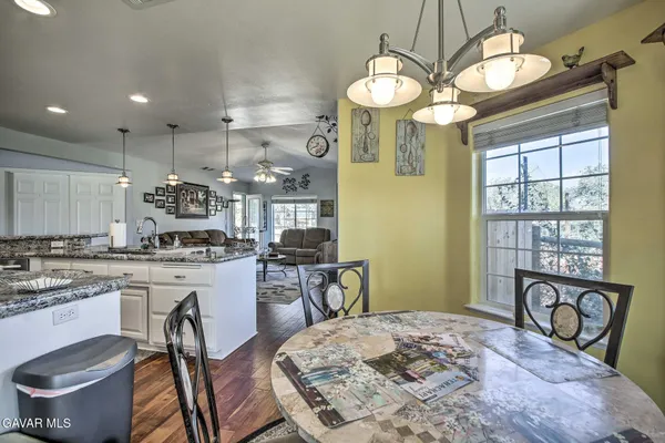 a kitchen with a table chairs stove and cabinets