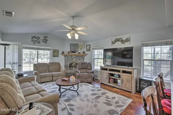 a living room with furniture a flat screen tv and a fireplace