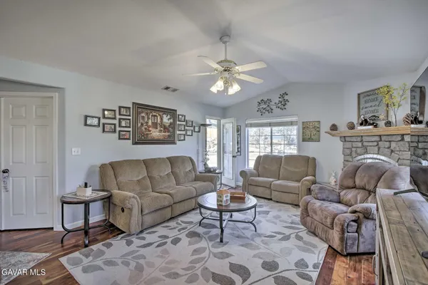 a living room with furniture a fireplace and a chandelier