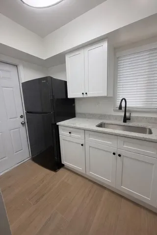 a kitchen with a refrigerator and cabinets